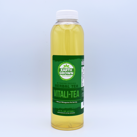 A bottle of Earth Grown Wellness brand Kratom Vitali-Tea sits on a white background. Green label.